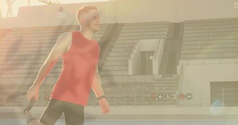 Athlete stretching on running track in bright sunlight