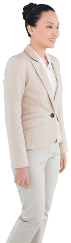 Asian businesswoman standing in stylish beige suit scans markets confidently