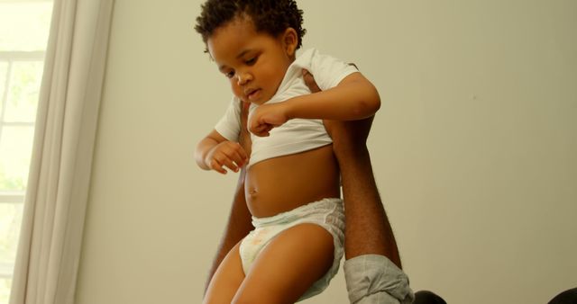 Father Lifting Toddler in Diaper Near Bright Window - Download Free Stock Images Pikwizard.com