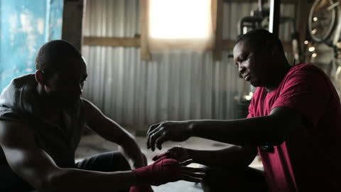 Athlete Prepares with Coach Wrapping Hands in Gym