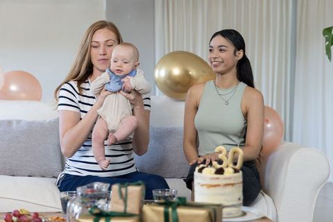Couple Celebrating Birthday with Baby in Cozy Living Room