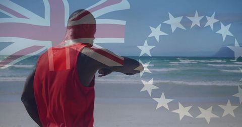 Man using smartwatch on beach with flag overlays