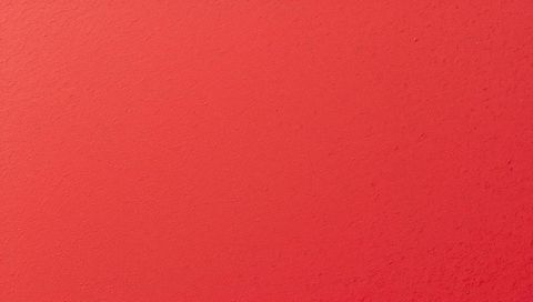 Warm coral plaster wall with subtle texture and soft gradient lighting