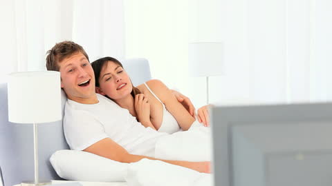 Happy Couple Relaxing Together in Bright Bedroom
