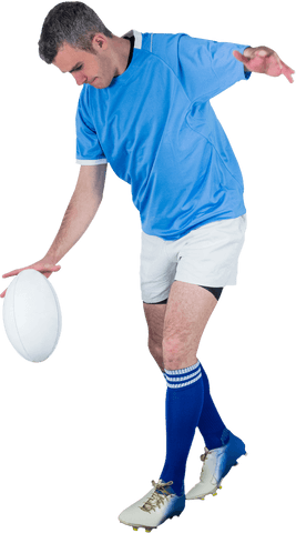 Determined rugby player kicking ball in transparent background