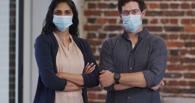 Colleagues Standing Confidently with Arms Crossed Wearing Face Masks - Download Free Stock Images Pikwizard.com