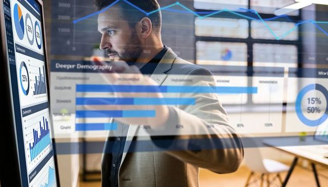 Businessman interacting with touchscreen analytics dashboards presenting data insights