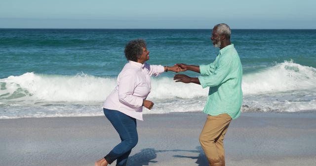 Senior Couple Dancing Playfully on Beach - Download Free Stock Images Pikwizard.com