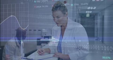 Female clinician updating patient records with digital data overlays in modern hospital