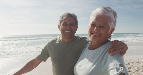 Happy Senior Couple Enjoying Beach Walk