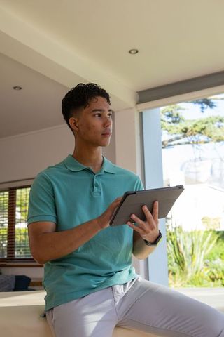 Young Man Using Tablet in Bright Modern Living Room