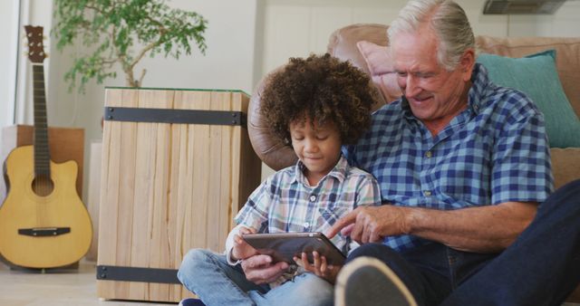 Grandfather and Grandson Using Digital Tablet Together at Home - Download Free Stock Images Pikwizard.com