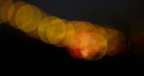 Vibrant Abstract Bokeh Lights Diagonally Across Dark Background