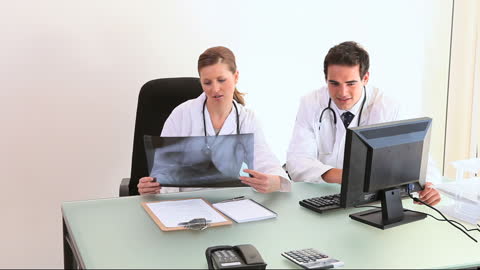 Team of Doctors Analyzing Patient X-ray in Medical Office