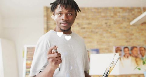 African american artist expressive in studio with paintbrush