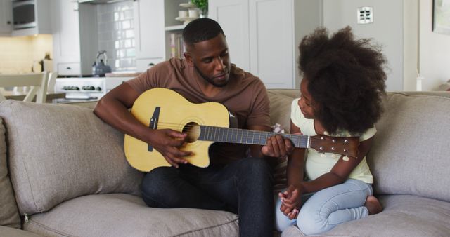 Father Teaching Daughter Guitar at Home on Comfortable Couch - Download Free Stock Images Pikwizard.com