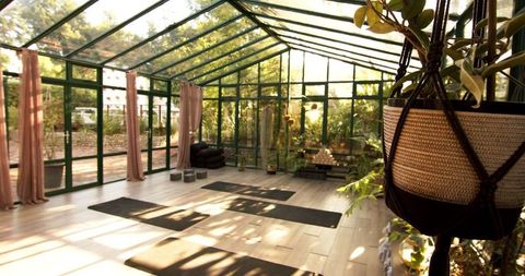 Sunlit Glasshouse Yoga Studio with Mats and Blocks