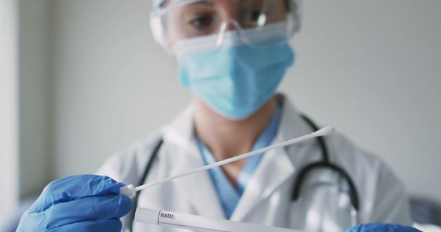 Healthcare Worker Holding Covid-19 Test Swab in Laboratory - Download Free Stock Images Pikwizard.com