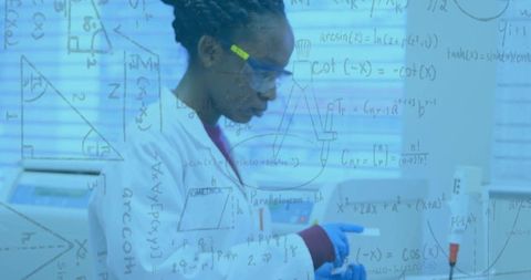 Scientist Analyzing Formulas in Modern Laboratory Setting