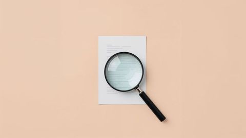 Magnifying Glass Over Document Illustrating Research and Investigation