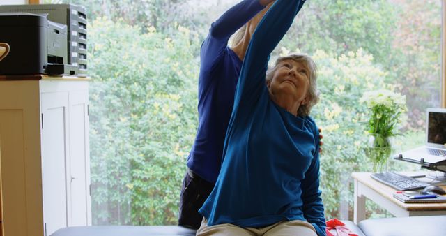 Senior woman receiving physical therapy at home, assisted by a health professional. Suitable for use in healthcare advertisements, elderly care services, medical blogs, rehabilitation programs, and illustrations of in-home medical support.