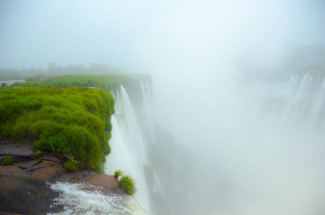 Misty Waterfalls with Lush Greenery on Cliffs Edge - Download Free Stock Photos Pikwizard.com