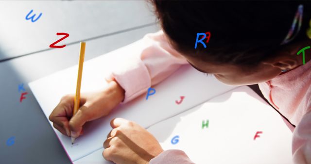 Image of floating colourful letters over girl sitting in classroom writing. education and learning concept digitally generated image.