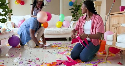 Family Cleaning Living Room After Birthday Celebration