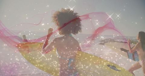 Sunlit beach scene with woman carrying yellow surfboard and flowing pink pareo
