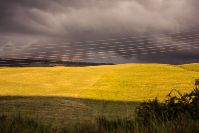 Dramatic Sky Over Rolling Hills with Power Lines - Download Free Stock Photos Pikwizard.com