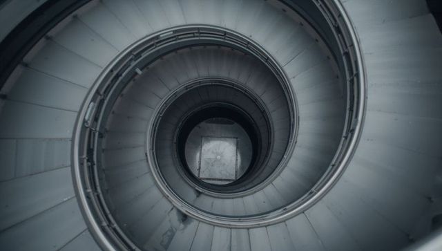 Monochrome spiraling staircase with industrial design