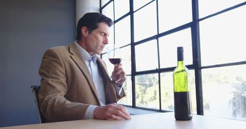 Executive Enjoying Red Wine Near Office Window - Download Free Stock Images Pikwizard.com