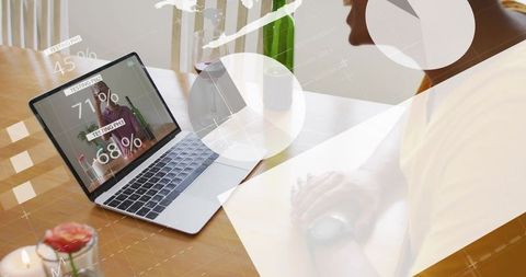 Remote worker clasping hands while viewing data analytics on laptop with overlay graphics