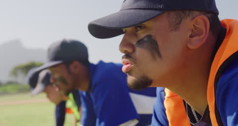 Focused Baseball Player Training with Team on Sunny Day