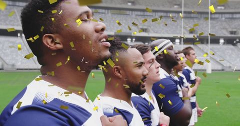 Multicultural Rugby Team Singing Under Falling Golden Confetti