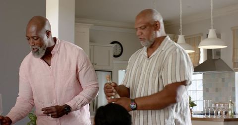 Senior Diverse Friends Celebrating With Champagne at Home