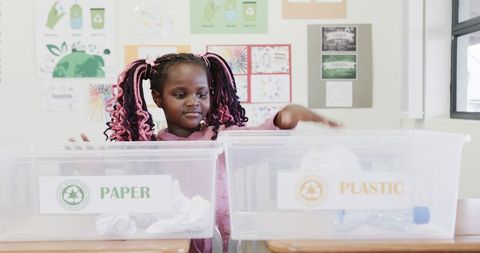 Child sorting recyclables in classroom promoting sustainability