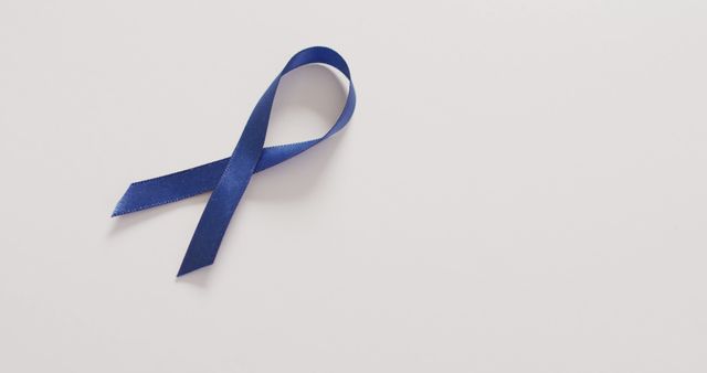 Image of dark blue colon cancer ribbon on white background. medical and healthcare awareness support campaign symbol for colon cancer.