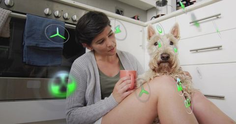 Woman cradling terrier on kitchen floor with futuristic green holograms cozy home moment