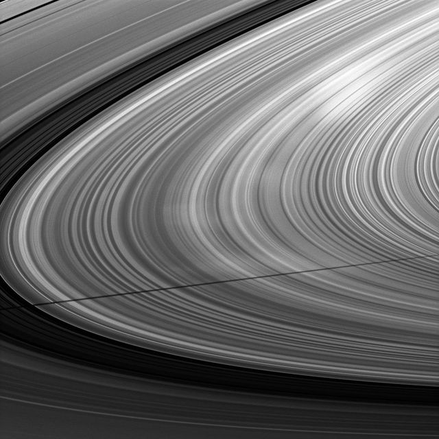 A moon shadow strikes Saturn rings near bright spokes on the B ring near the center of this image taken by NASA Cassini spacecraft about one month after the planet August 2009 equinox.