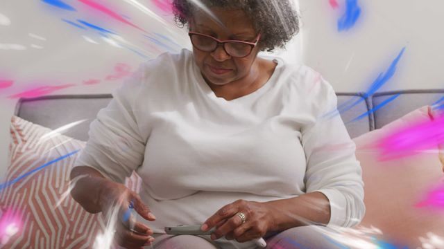 Senior African American woman using smartphone with animated light trails portraying global connections. Perfect for concepts related to technology in everyday life, digital inclusion of older adults, connectivity, and data processing. Ideal for websites, blogs, and articles about technology, aging, and digital communication.