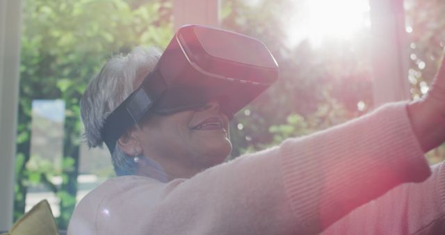 Senior Woman Using Virtual Reality Headset at Home in Sunlit Room - Download Free Stock Images Pikwizard.com