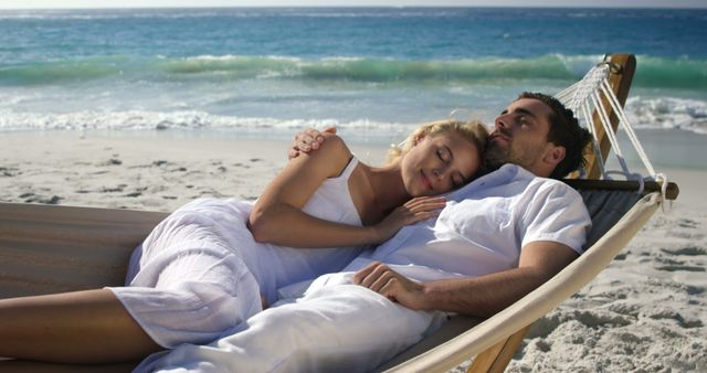 Couple relaxing in hammock at the beach