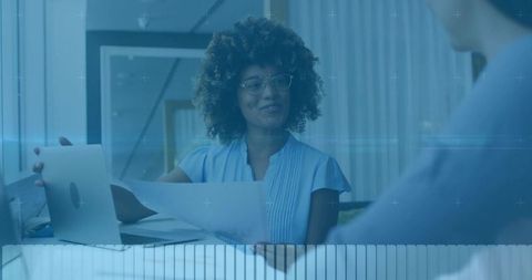 Professional Woman Handing Document in Modern Office Setting