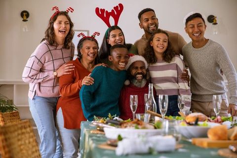 Diverse Family Celebrating Christmas Around Table with Joyful Atmosphere