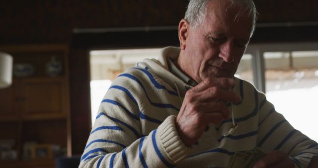 Senior Man Sitting Indoors Counting Money Pocket Change - Download Free Stock Images Pikwizard.com