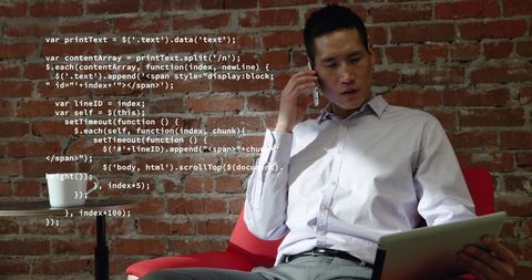 Businessman Analyzing Data on Tablet Making Phone Call