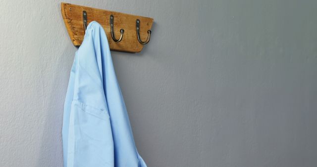 Light Blue Shirt Hanging on Wooden Wall Hook - Download Free Stock Images Pikwizard.com