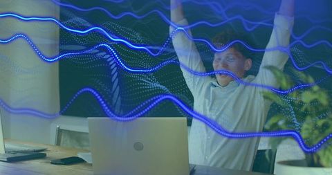 Male professional celebrating laptop success with futuristic blue data waves