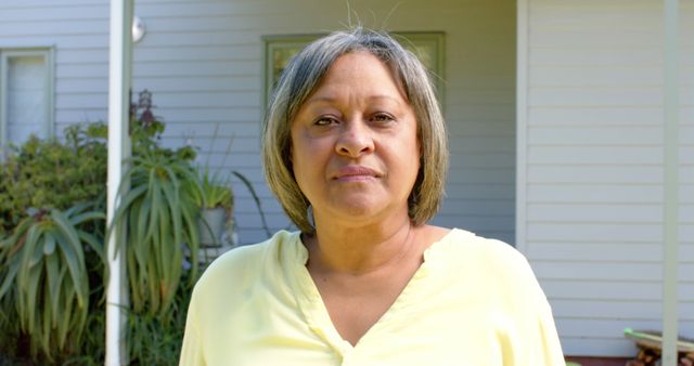 Middle-aged Woman Standing in Front of Suburban Home - Download Free Stock Images Pikwizard.com